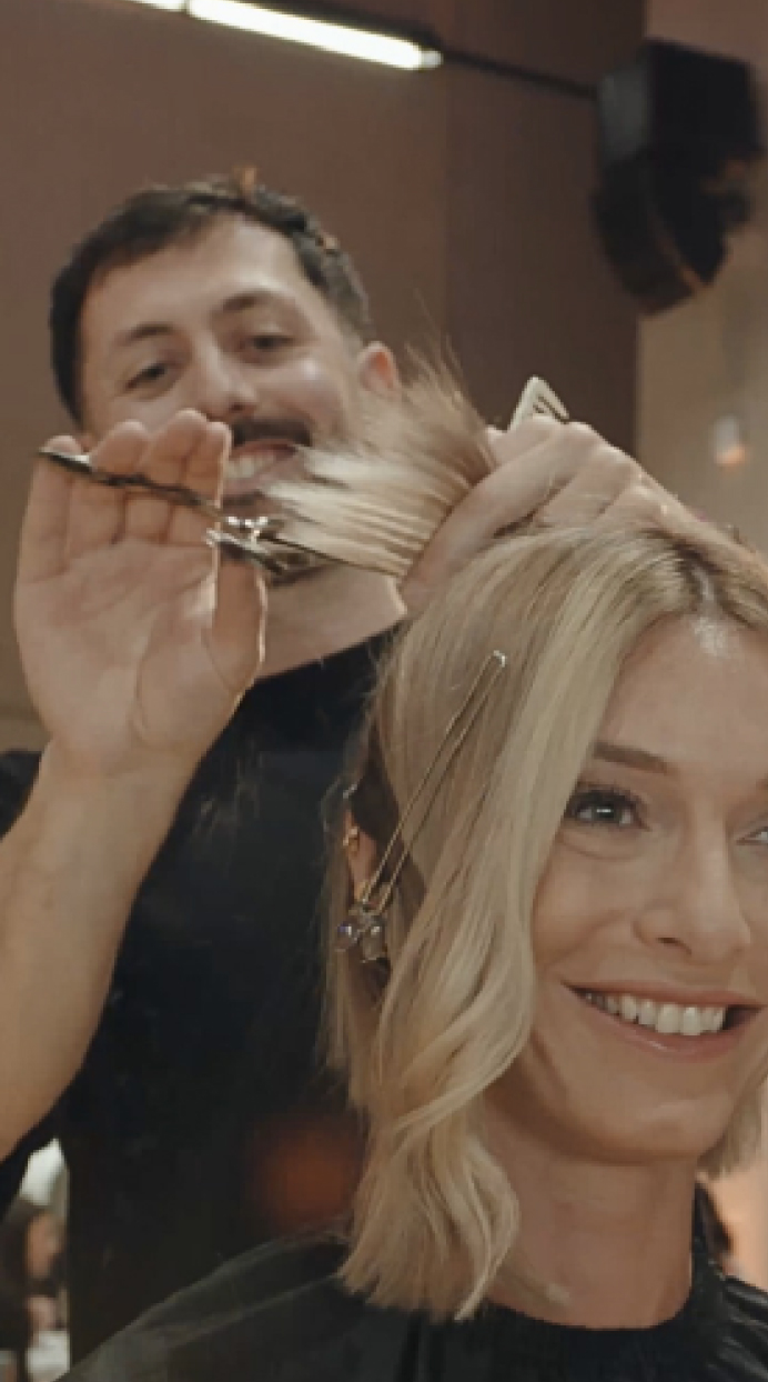 A hairdresser cutting hair in a salon